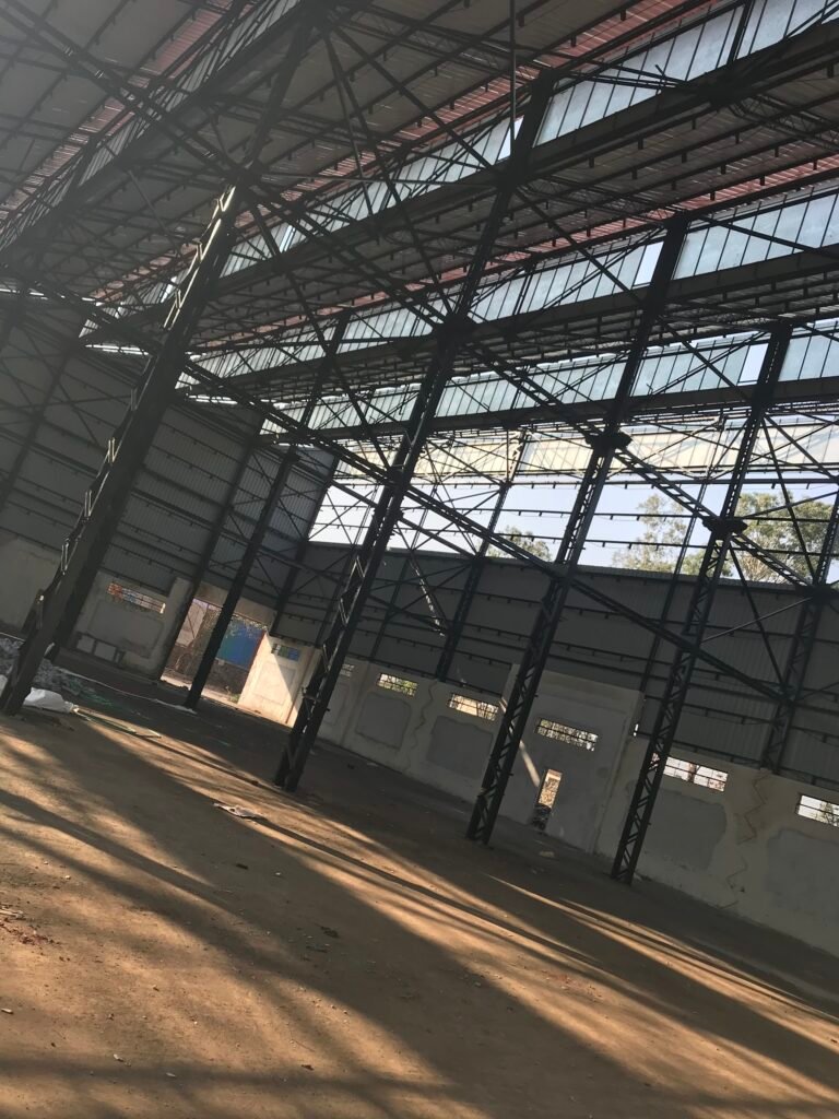 Steel roof trusses and columns inside an industrial shed